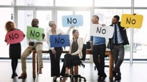 a group of people holding signs that say no