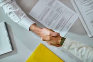 two individuals shaking hands after an interview