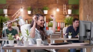 happy-successful-excited-businesswoman-sitting-at-desk