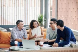 business-people-listening-to-colleague in office