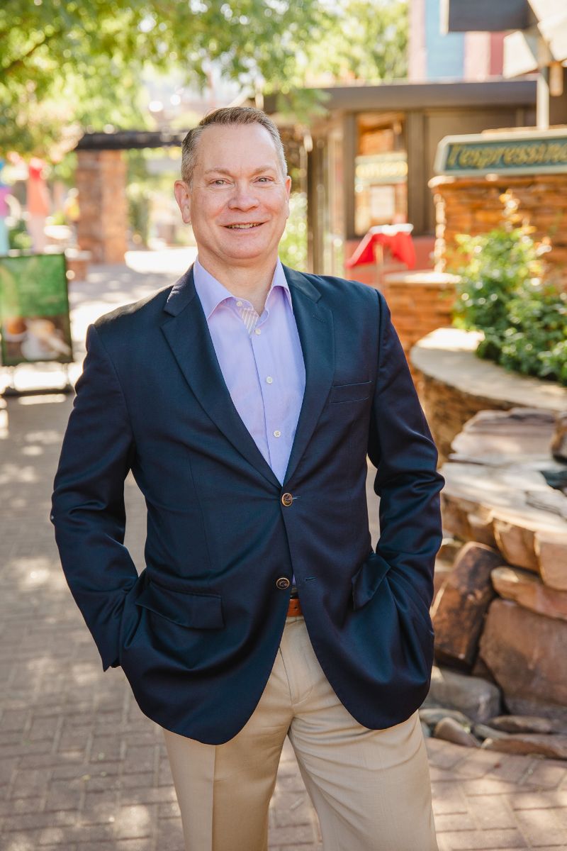 Ken is standing with his hands in his pockets in Uptown Sedona.