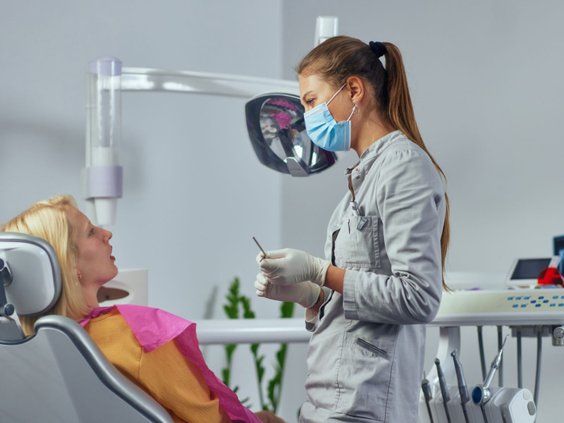 Dentist Performing Dentistry Services on Patient