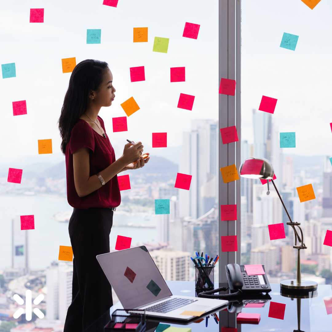 woman surrounded by sticky notes in her office