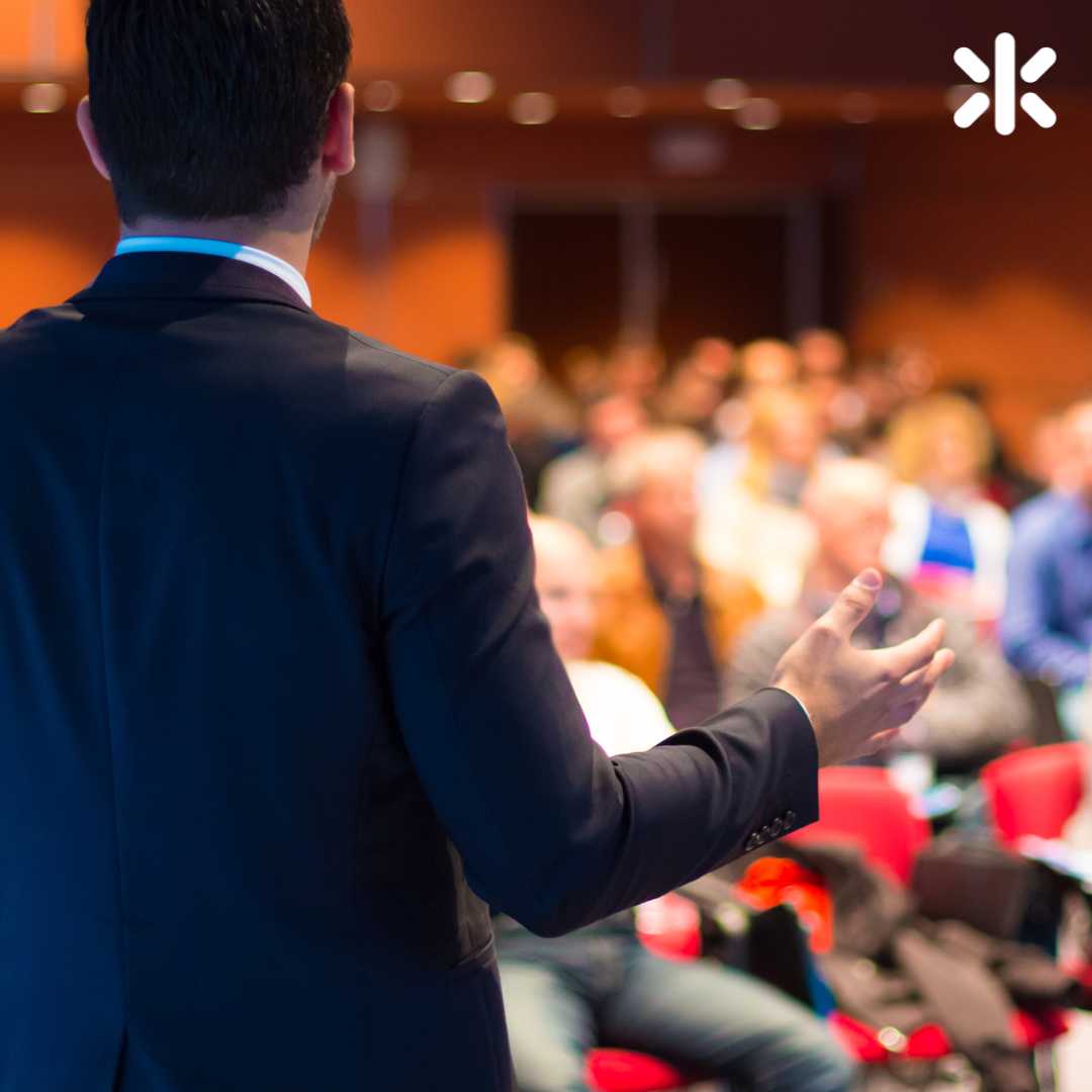 male speaking to a room of people