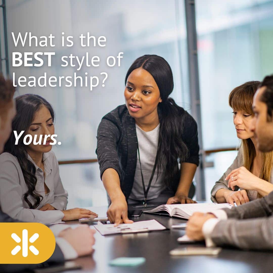 woman in board room in leadership position explaining and pointing to paper on desk with other folks around the table with overlay quote: </p>
<p>What is the BEST style of leadership? YOURS.