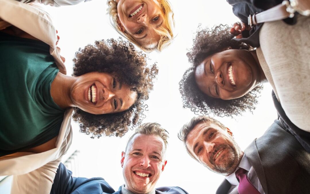 group of happy employees looking down at the camera