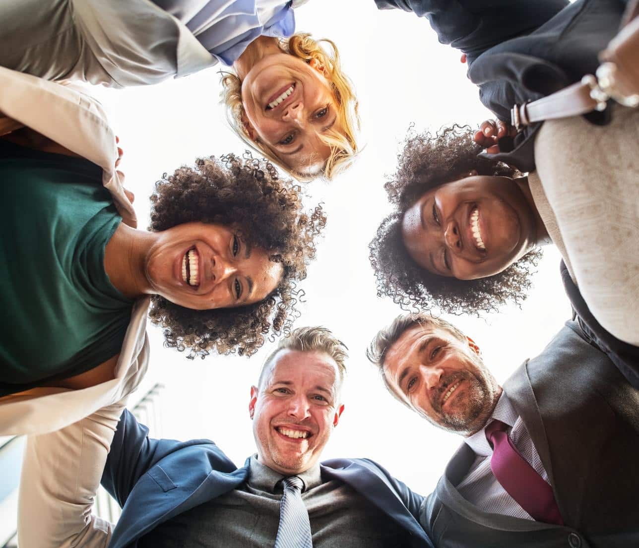 group of happy employees looking down at the camera