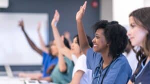 medical professionals raising their hand to speak