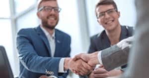 Two business men shaking hands with new banker