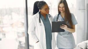 too female presenting doctors looking at a chart