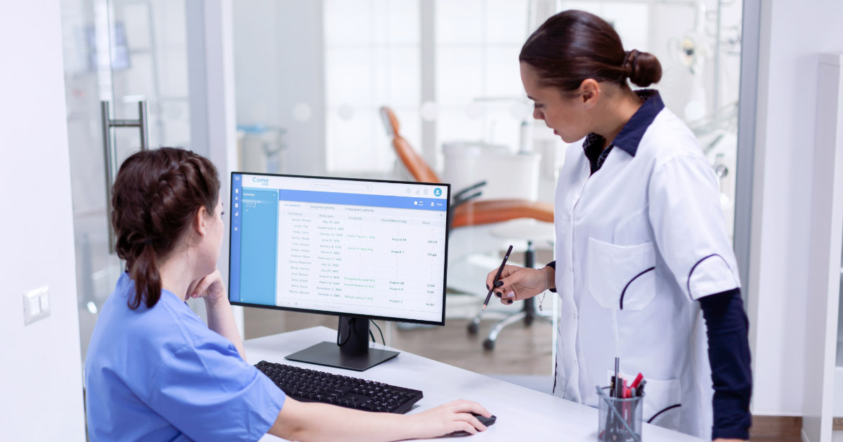 Dentist and office manager reviewing performance metrics together