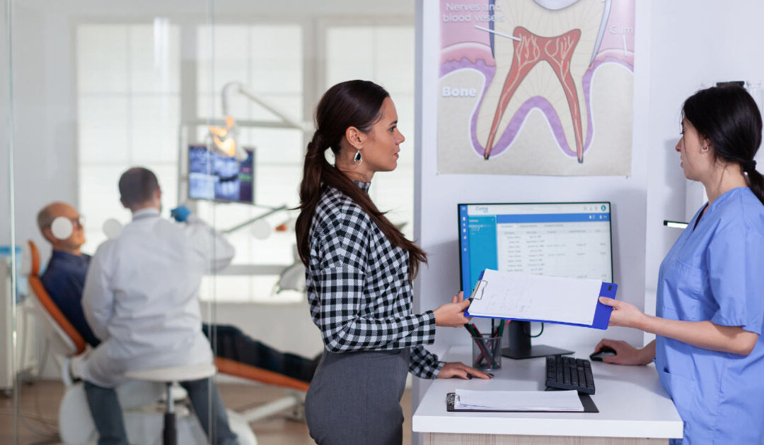 Modern dental office showing patient being cared for and another checking out