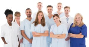 Group of 10 staff members at local dentist office posing for picture