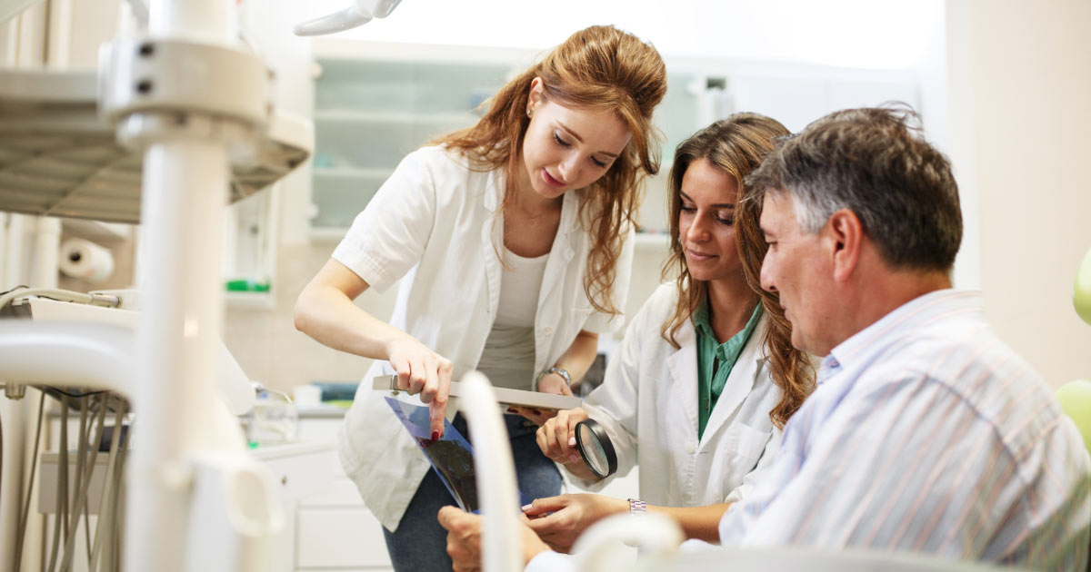 Seasoned dental experts reviewing a complicated patient chart