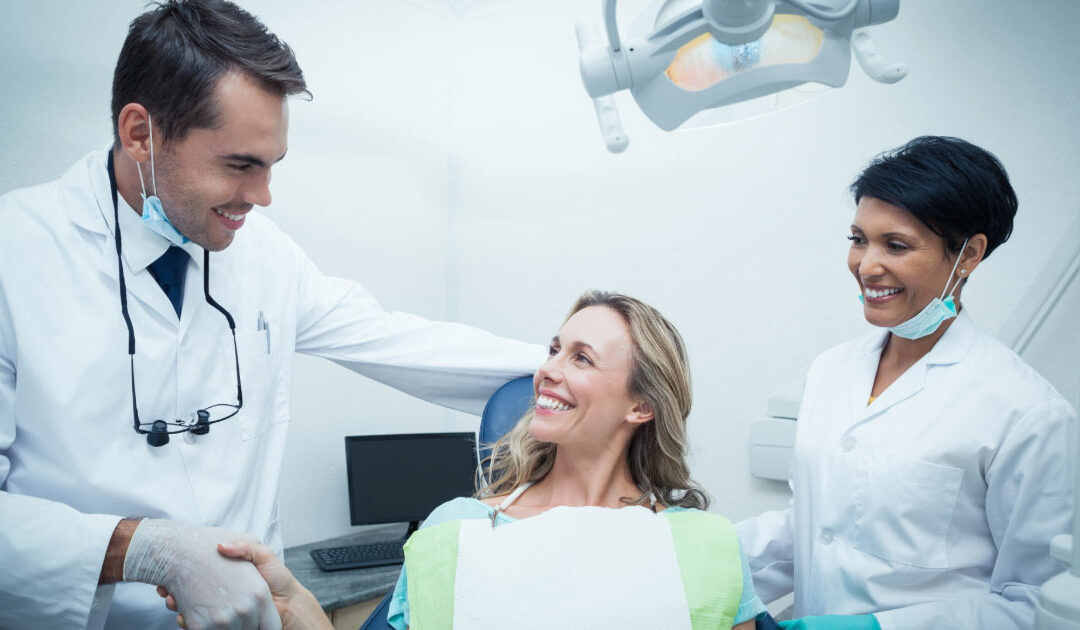 Woman sitting in dental chair meeting her dentist for the first time