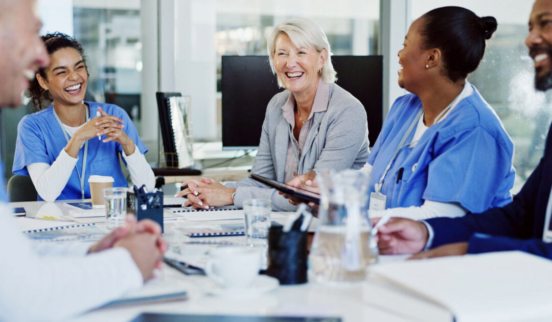 Group of medical professionals in meeting with their business coach