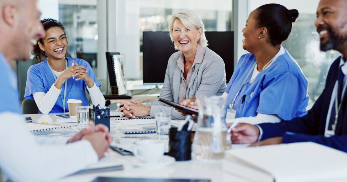 Group of medical professionals in meeting with their business coach