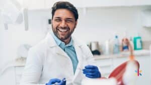 Smiling dentist in a Flagstaff Arizona dental office representing strong team culture and leadership developed through dental coaching