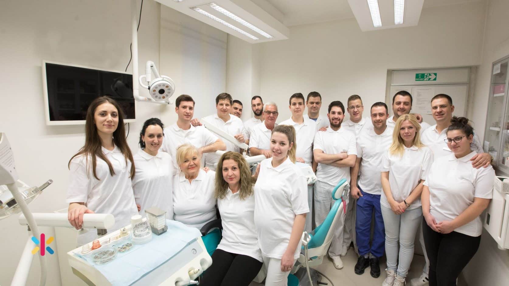 Full dental office team standing together inside a modern dental clinic.