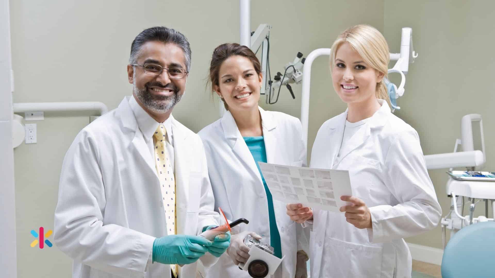 Dental professionals reviewing patient information together in a dental clinic.
