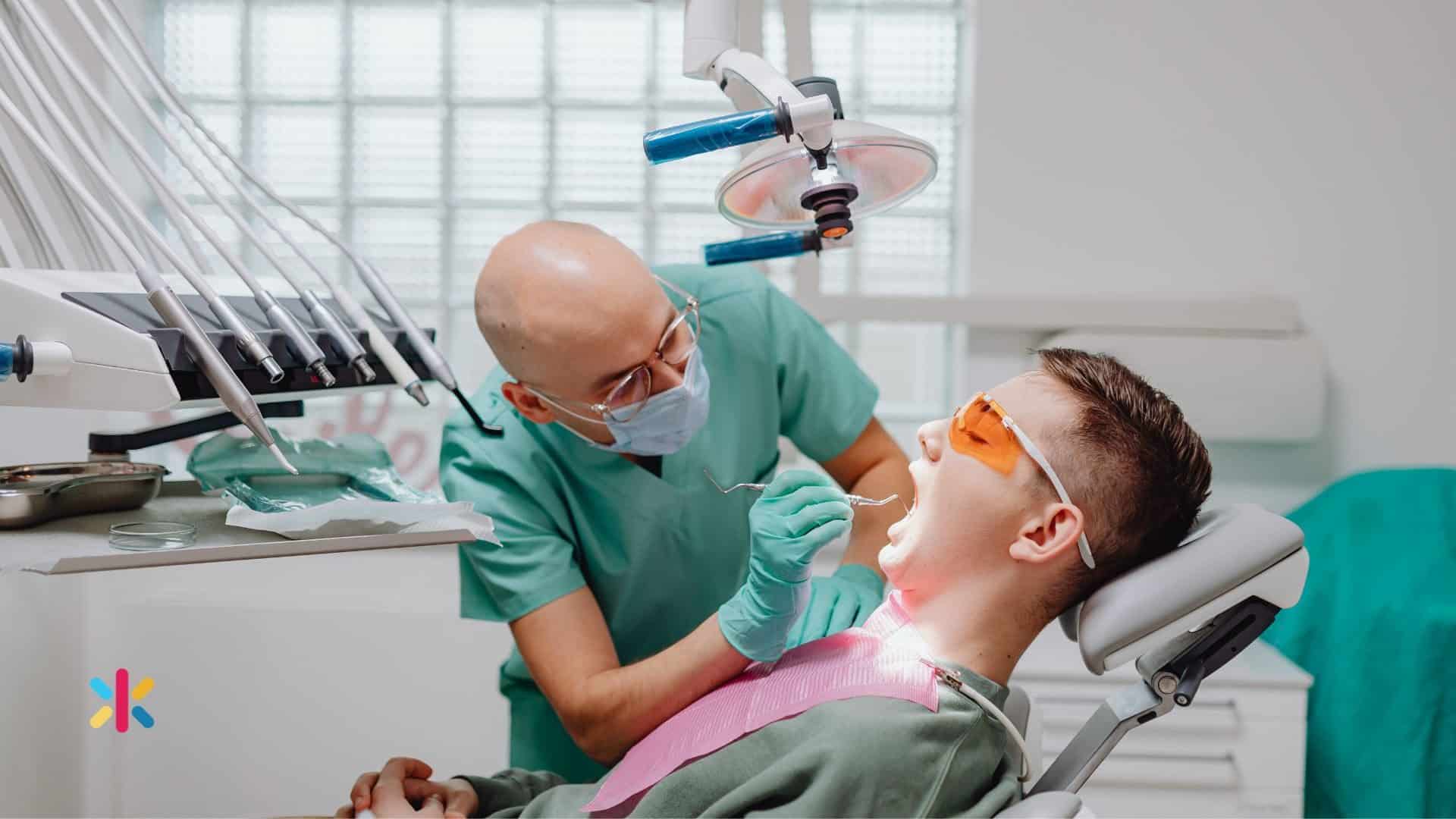 Dentist performing a dental exam on a patient in a dental chair.