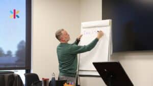 Ken Kilday Leadership Coach, writing on a sheet at a workshop