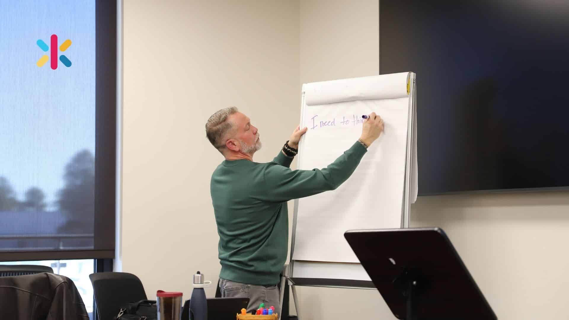 Ken Kilday Leadership Coach, writing on a sheet at a workshop