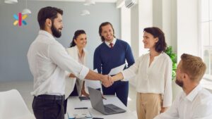 Promoting from within: a leader shaking hands with a team member during a team meeting